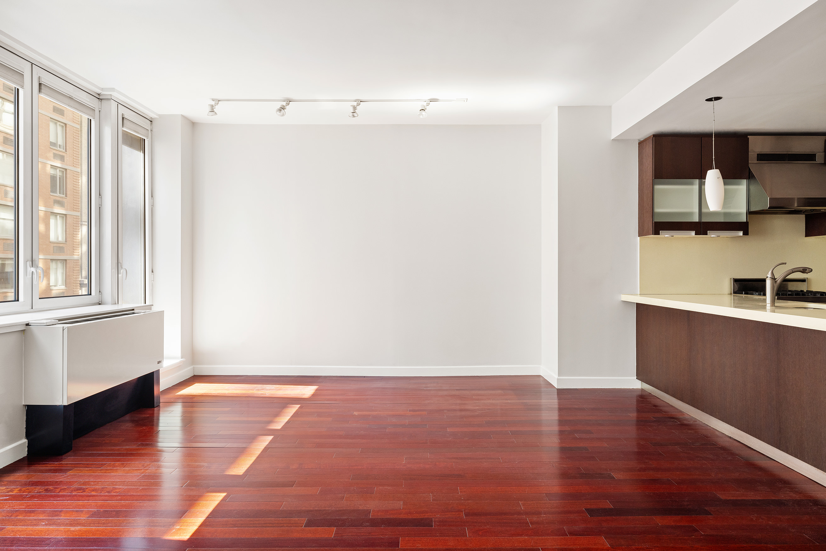 125 West 21st Street, Unit 5B Manhattan, NY 10011 - Photo 4 of 15 a view of a room with wooden floor and cabinet