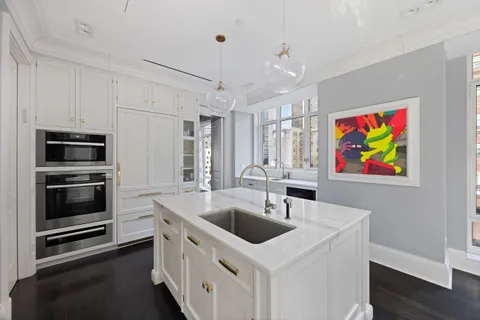 a kitchen with stainless steel appliances a stove a sink and a microwave