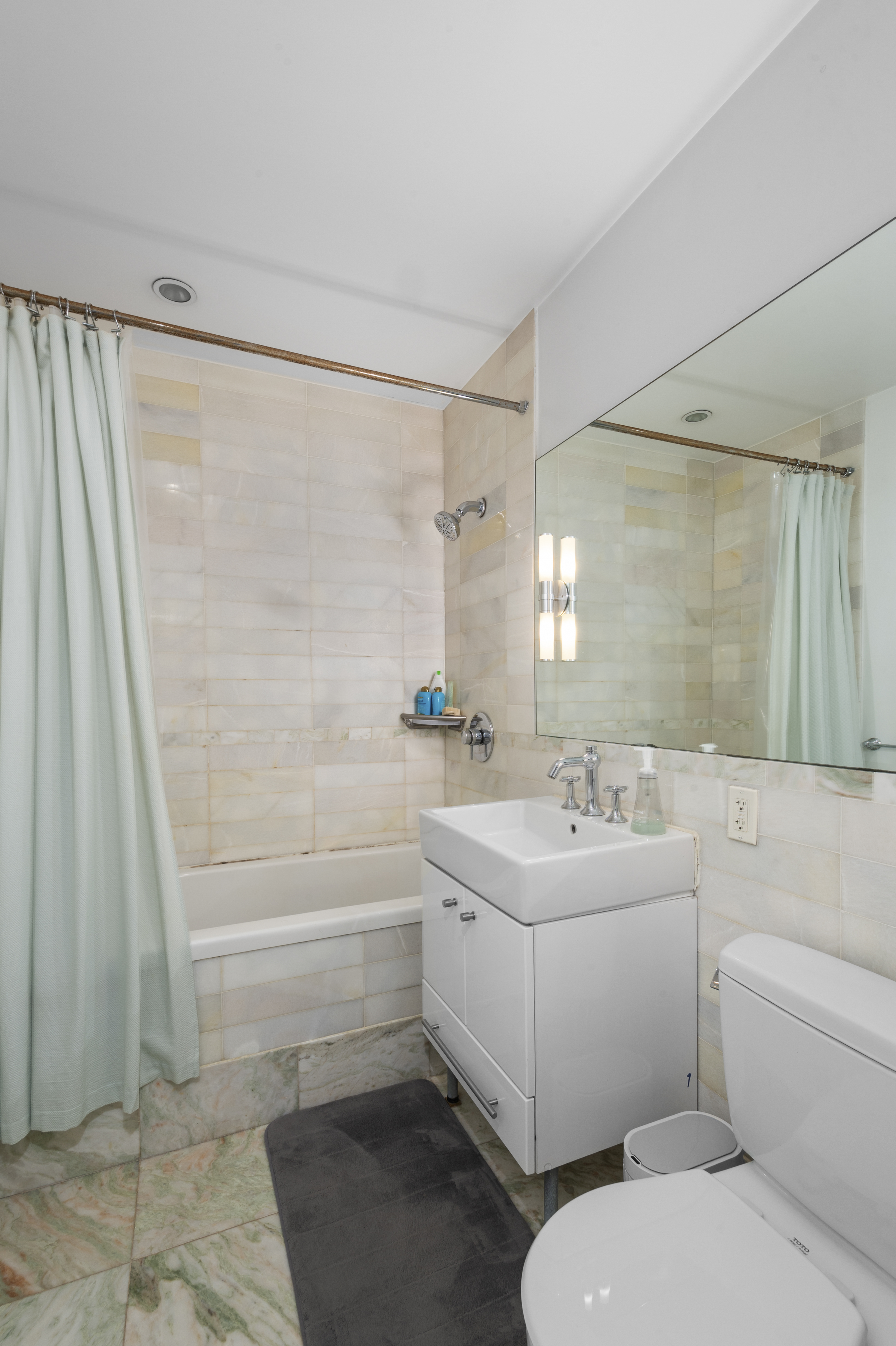 635 West 42nd Street, Unit 14K Manhattan, NY 10036 - Photo 9 of 19 a bathroom with a sink toilet and shower