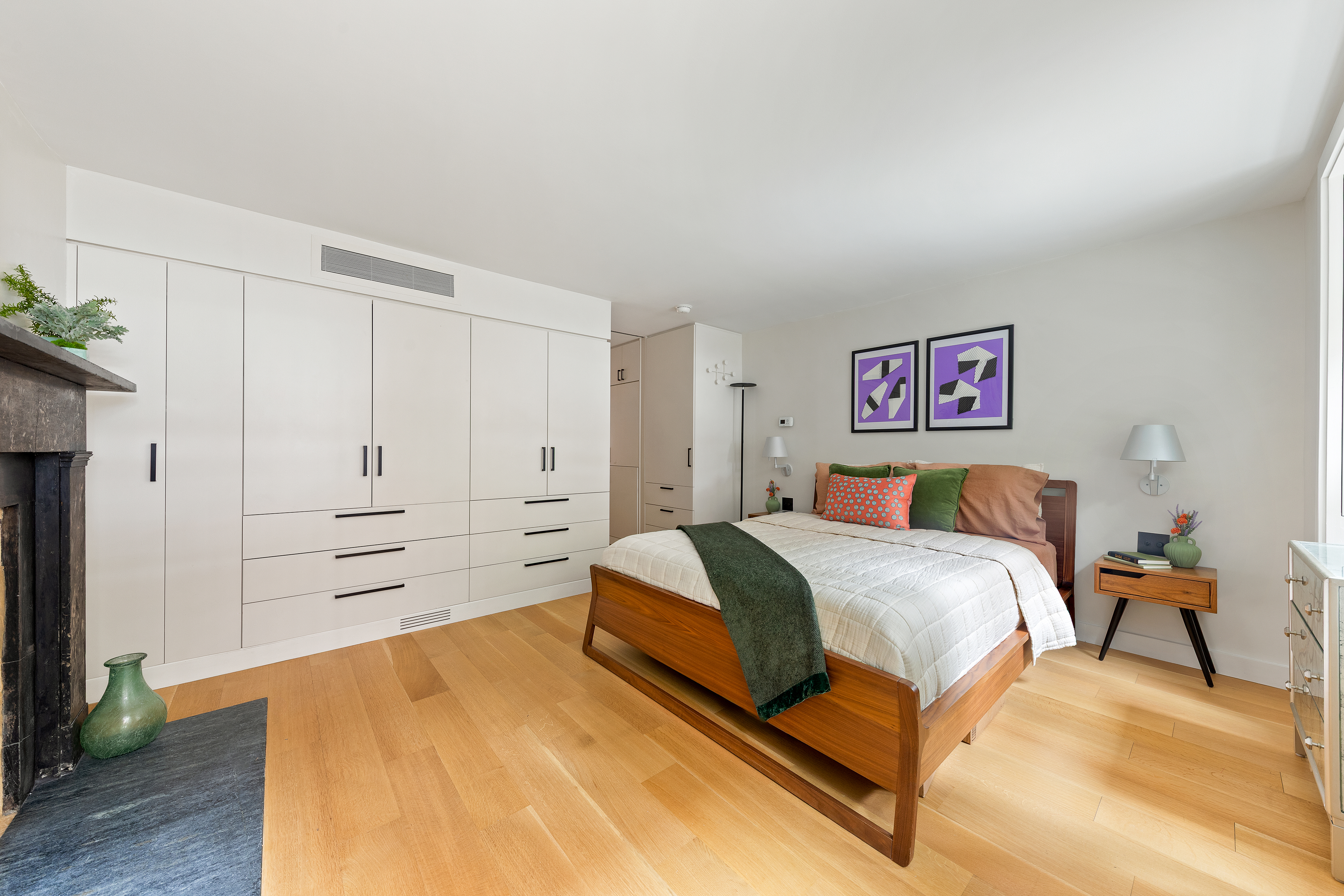 21 Bethune Street, Unit GARDEN Manhattan, NY 10014 - Photo 7 of 12 a spacious bedroom with a bed and a chandelier