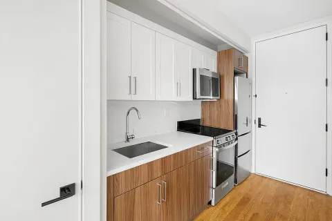 a kitchen with stainless steel appliances a refrigerator and a stove