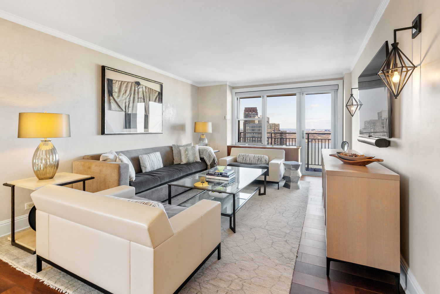 201 West 70th Street, Unit 29KL Manhattan, NY 10023 - Photo 4 of 20 a living room with furniture and a flat screen tv