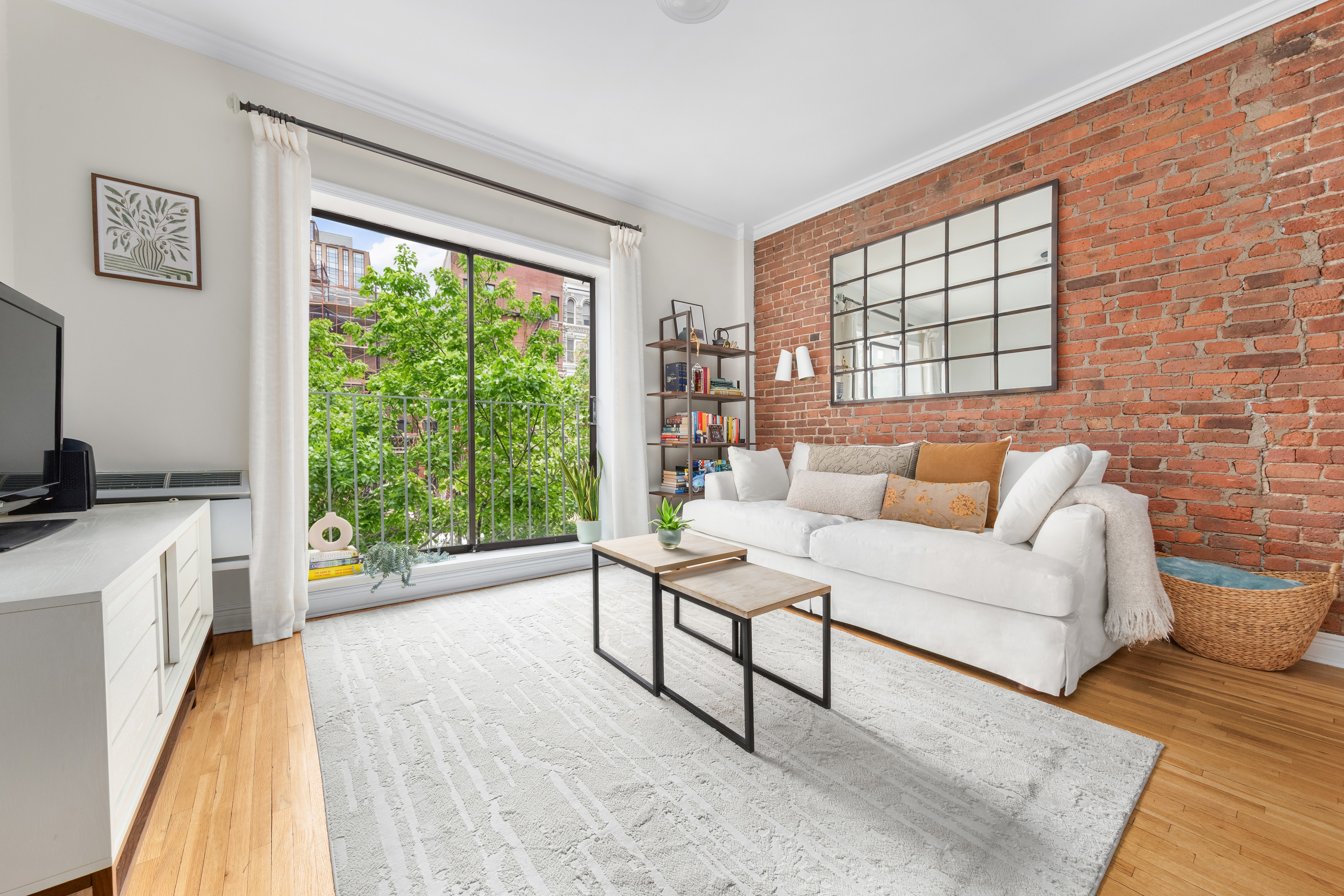 207 East 21st Street, Unit 5B Manhattan, NY 10010 - Photo 1 of 7 a living room with furniture and a window