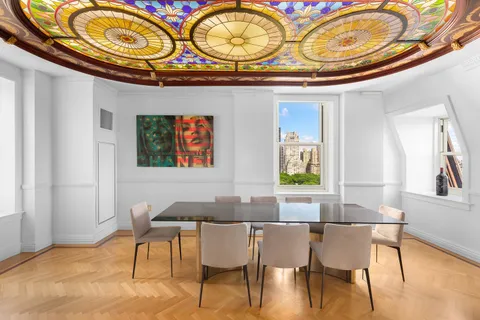 a view of a dining room with furniture and chandelier