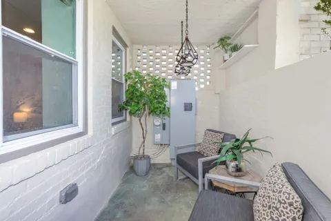 a vase of flowers sitting on a floor in front of a window
