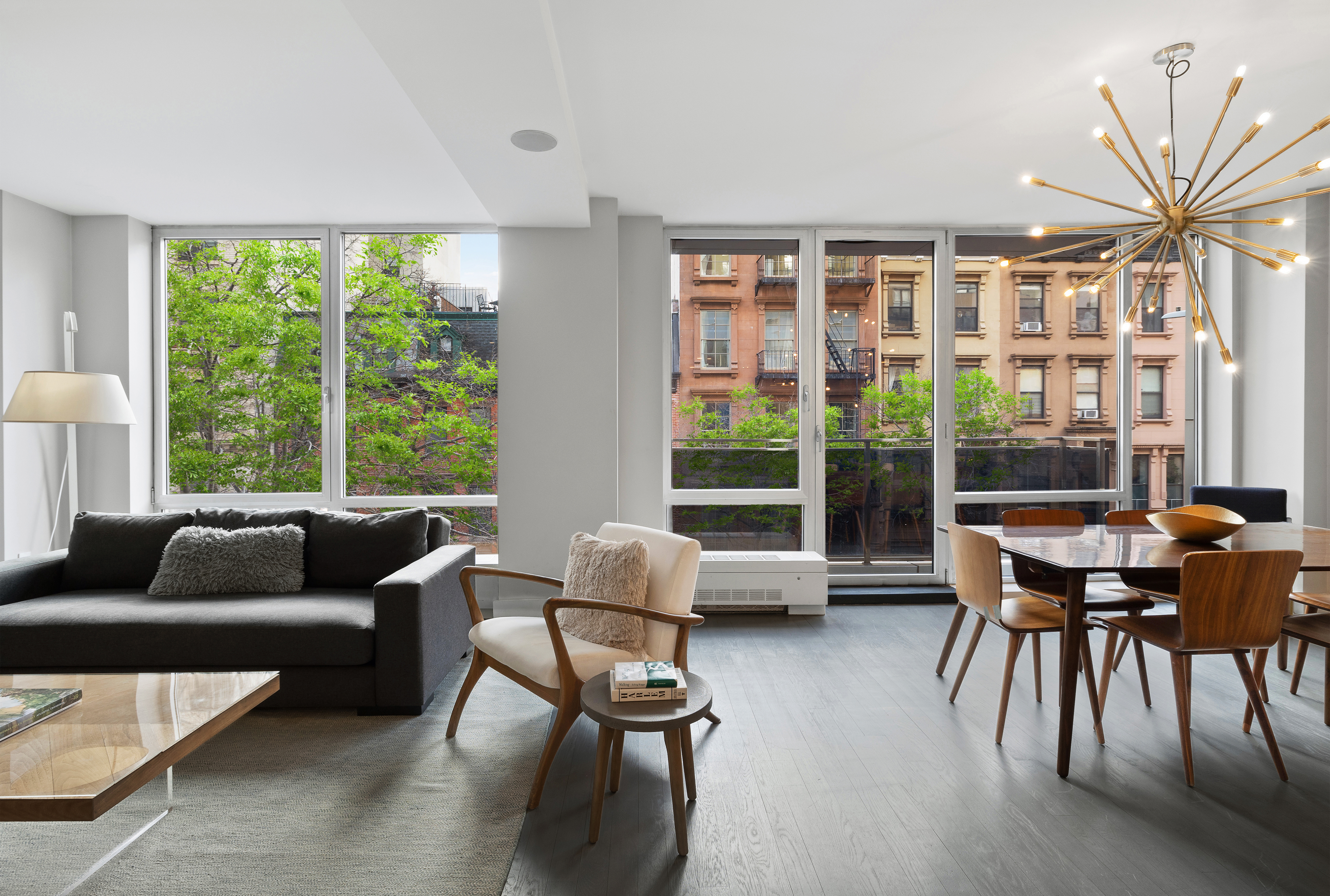 129 West 123rd Street, Unit 3 Manhattan, NY 10027 - Photo 3 of 20 a living room with furniture and a large window