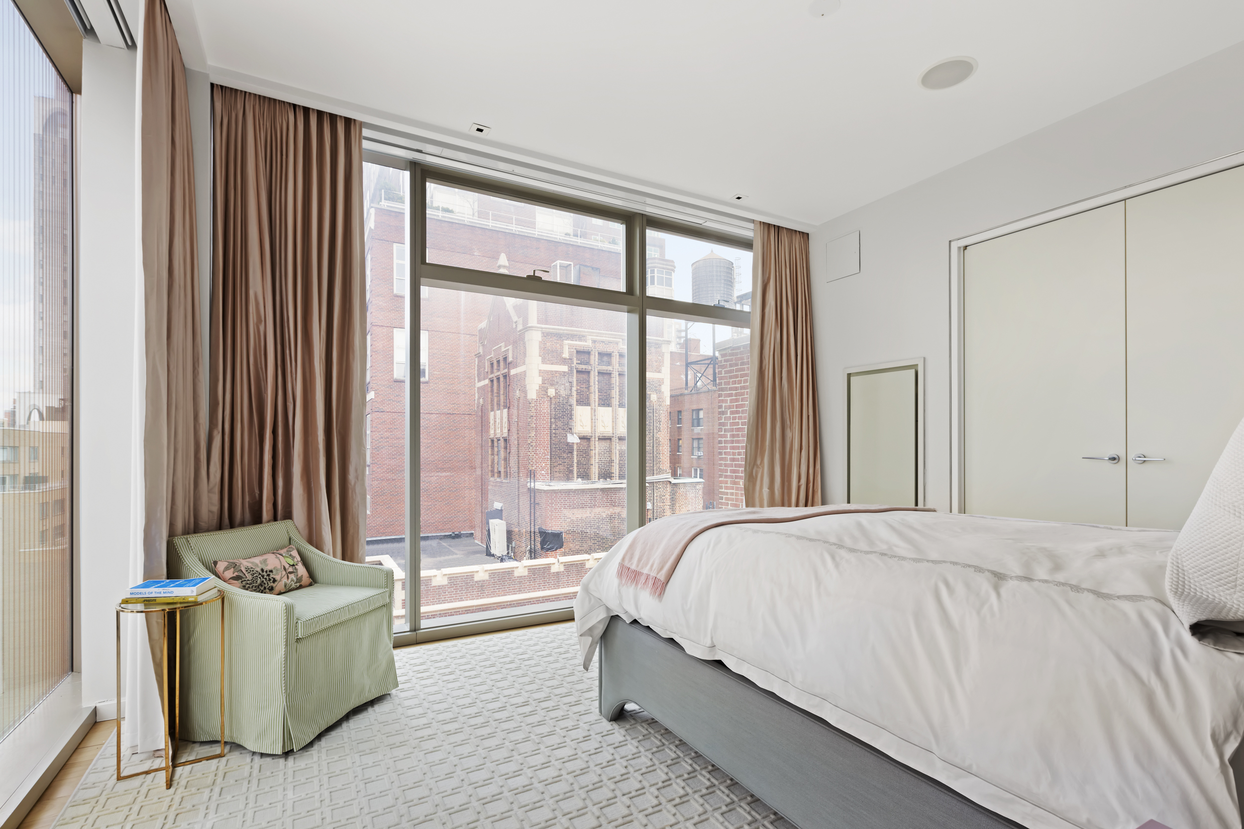 1055 Park Avenue, Unit PH Manhattan, NY 10028 - Photo 14 of 19 a bedroom with a bed and a large window