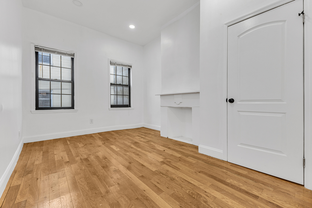 583 Evergreen Avenue Brooklyn, NY 11221 - Photo 4 of 12 a view of empty room with wooden floor and fan