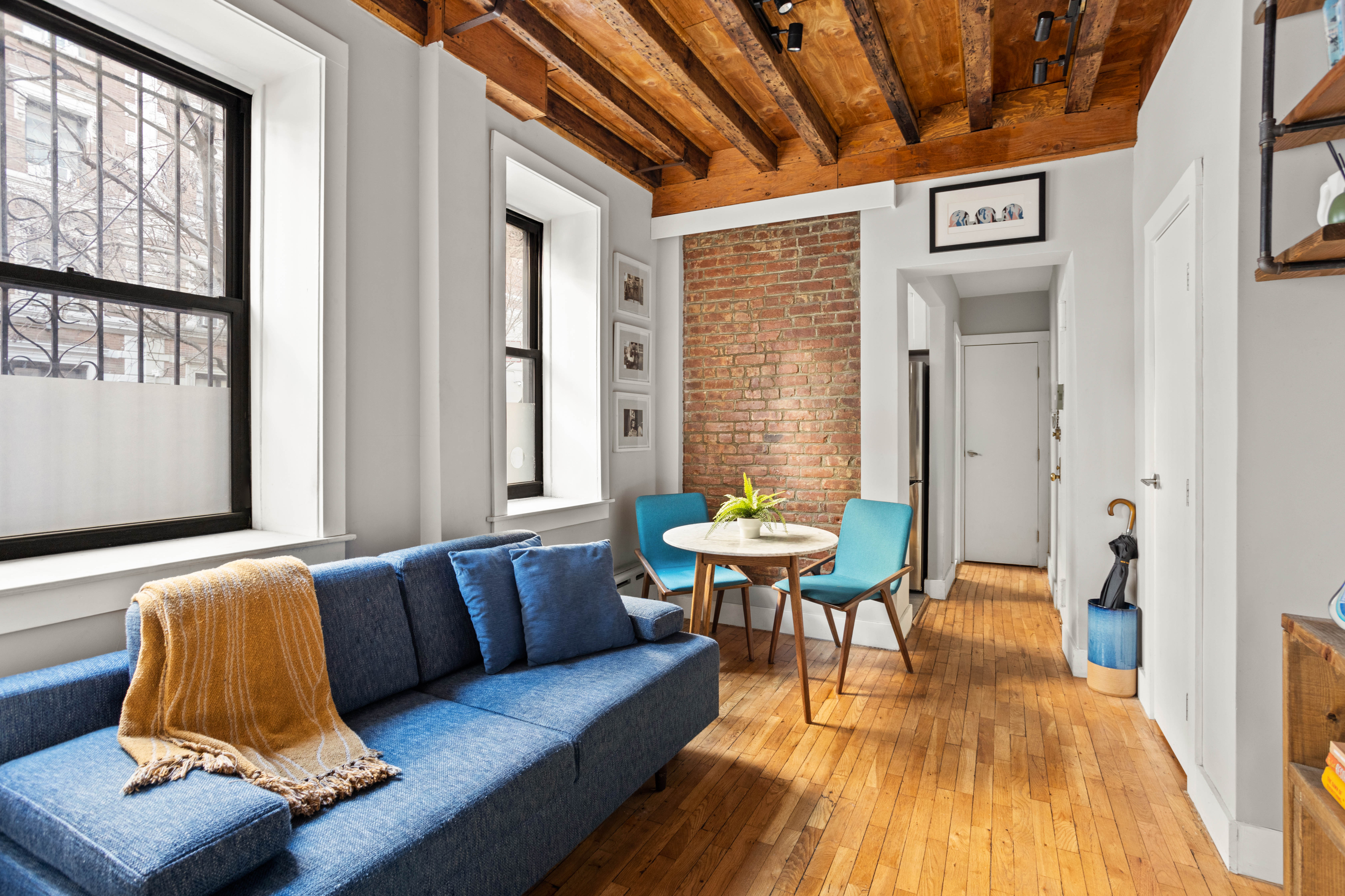 4 West 101st Street, Unit 5 Manhattan, NY 10025 - Photo 1 of 9 a living room with furniture and a wooden floor