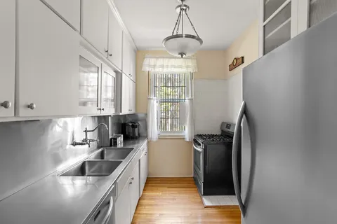 a kitchen with a refrigerator a sink and cabinets