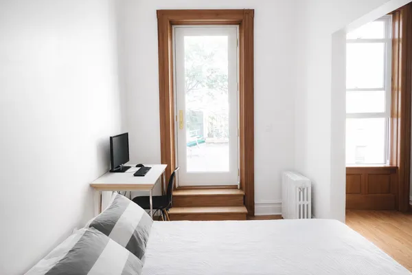 a bedroom with a bed and a window