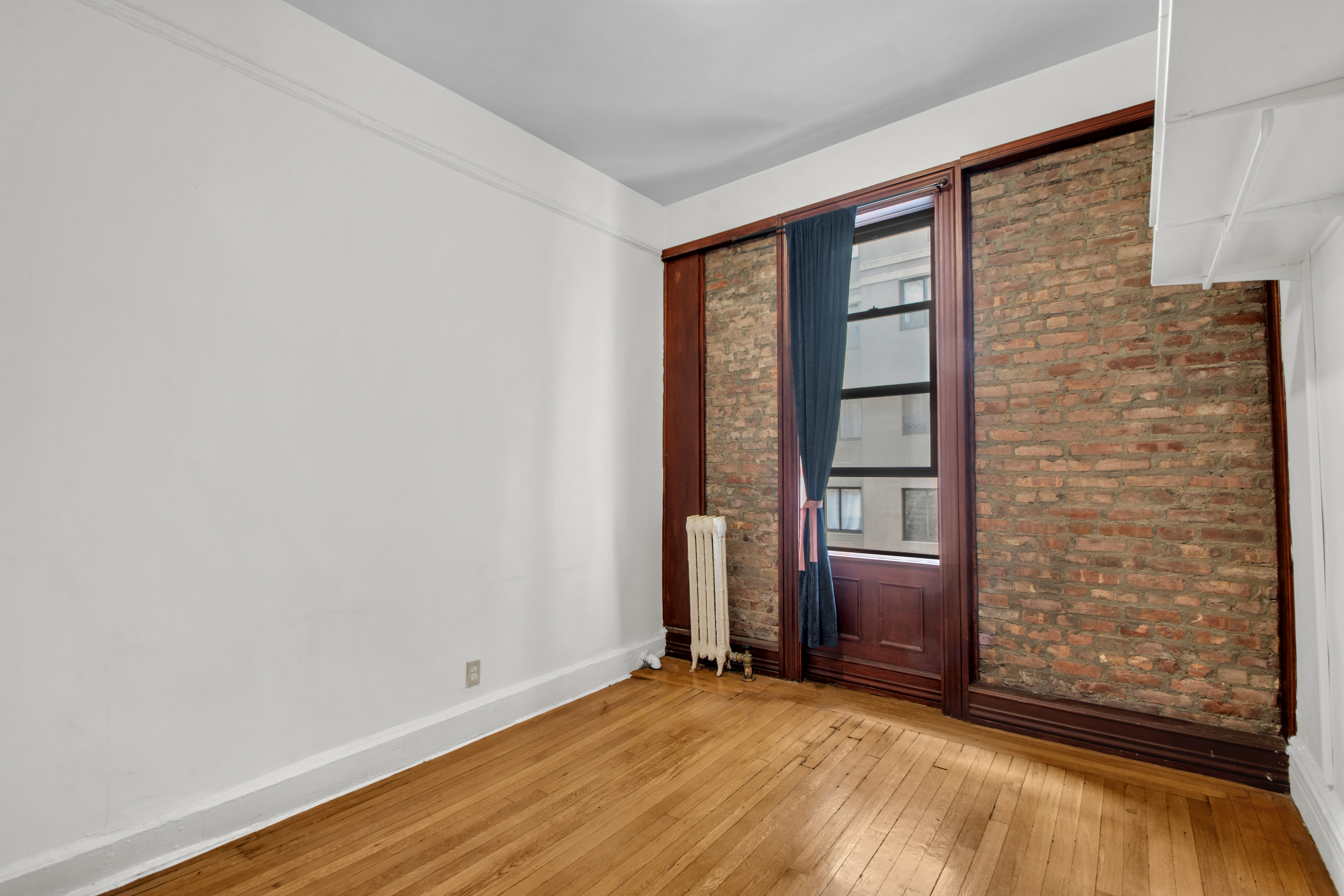 244 Riverside Drive, Unit 4D Manhattan, NY 10025 - Photo 3 of 9 wooden floor and window in an empty room