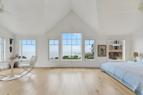 a spacious bedroom with a large bed and a couch