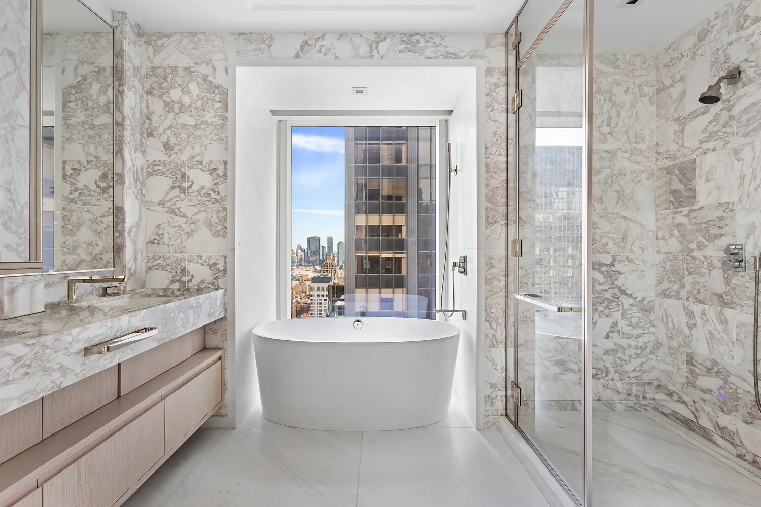 a bathroom with a bathtub and double sink