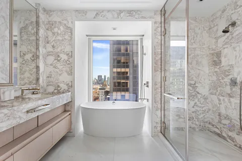 a bathroom with a bathtub and double sink