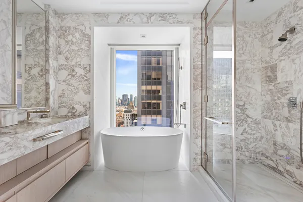 a bathroom with a bathtub and double sink