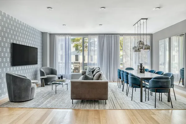 a living room with furniture a flat screen tv and a large window