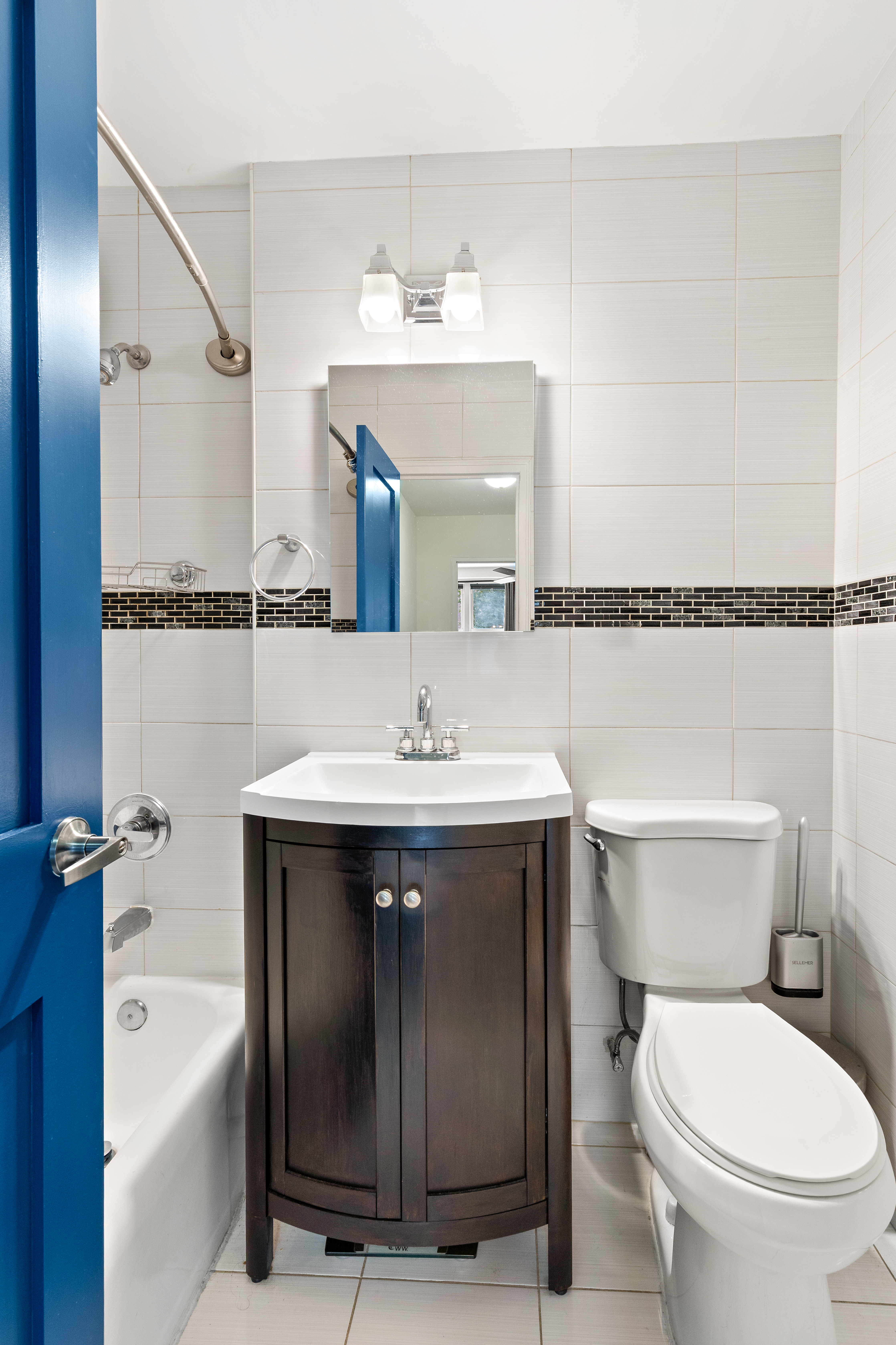 1655 Flatbush Avenue, Unit B210 Brooklyn, NY 11210 - Photo 5 of 5 a bathroom with a sink mirror toilet and bathtub