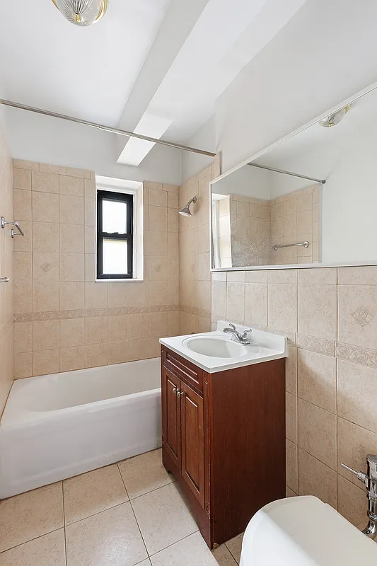 40 Clarkson Avenue, Unit 2L Brooklyn, NY 11226 - Photo 5 of 11 a bathroom with a sink a toilet and bathtub