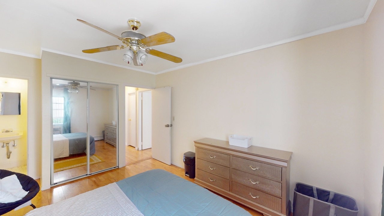 495 Central Avenue, Unit 2 Brooklyn, NY 11221 - Photo 8 of 19 a bedroom with a bed and a chandelier
