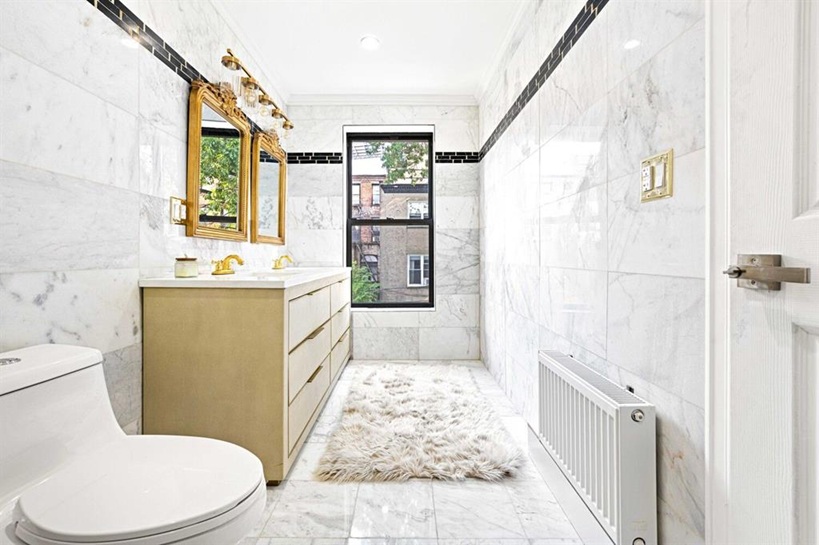 308 Clifton Place Brooklyn, NY 11216 - Photo 17 of 41 a bathroom with a sink a toilet a mirror a vanity and shower