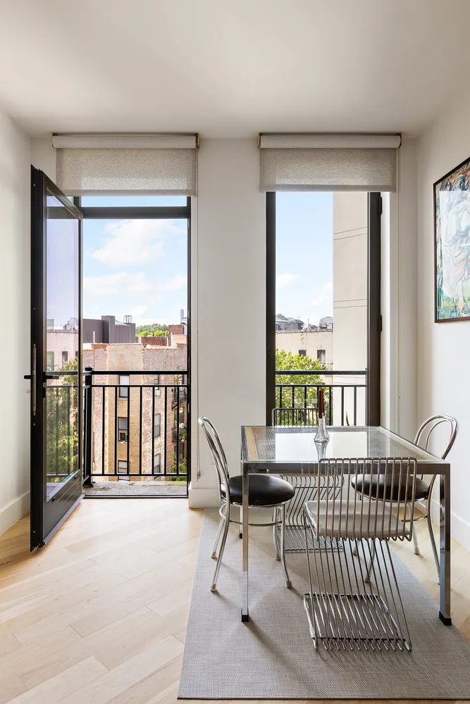 a large bed sitting in a bedroom next to a window