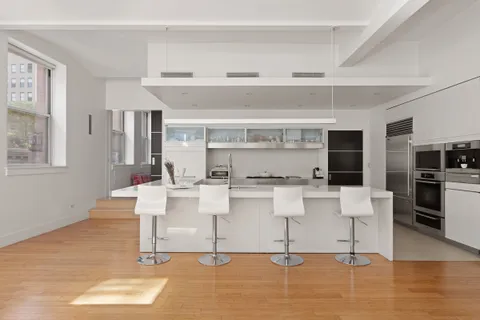 a living room with fireplace furniture and a wooden floor