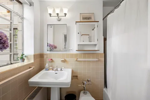 a bathroom with a sink a toilet and mirror