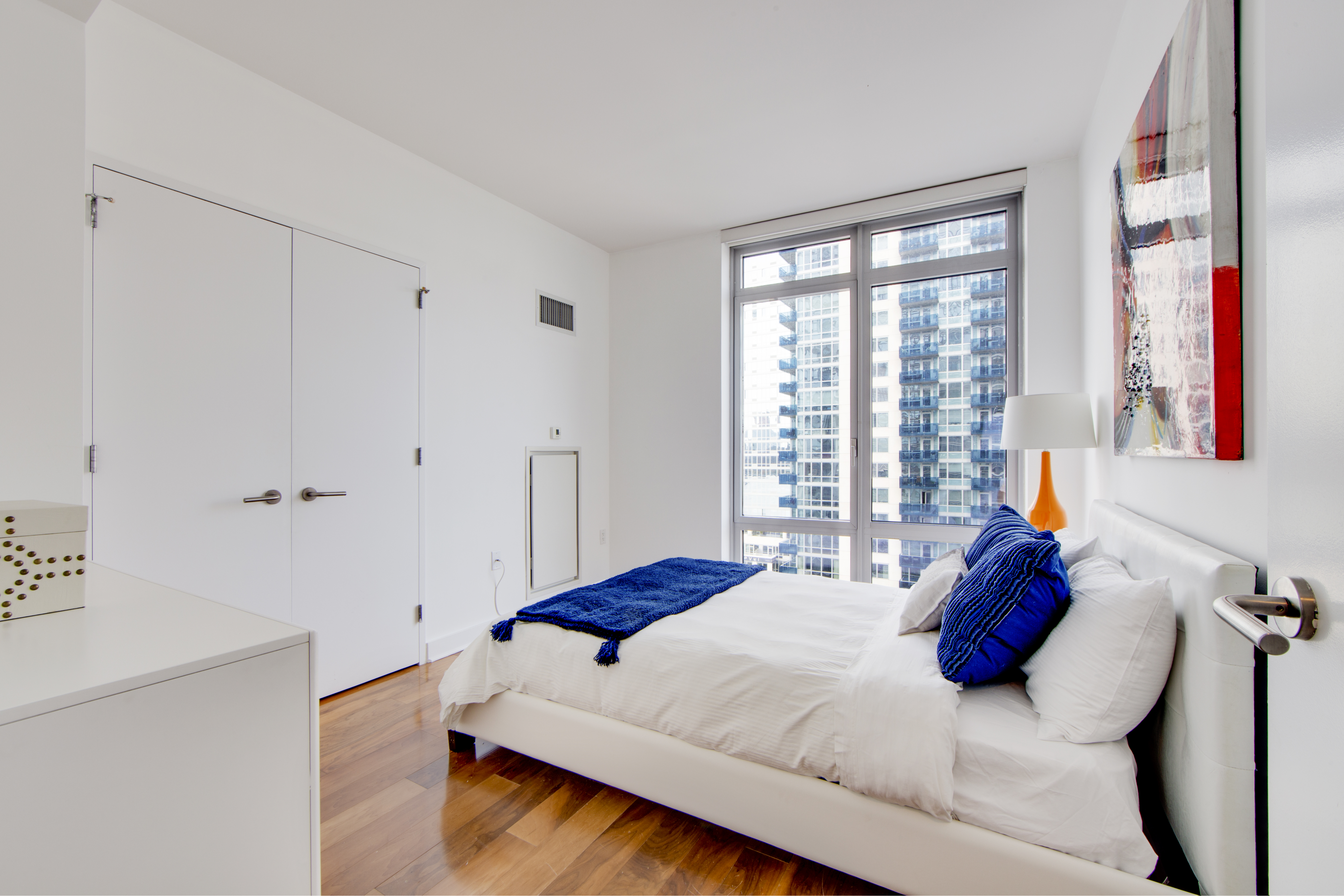 2 Northside Piers, Unit 8H Brooklyn, NY 11249 - Photo 11 of 20 a bedroom with a bed and a window