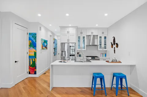 a kitchen with stainless steel appliances kitchen island granite countertop a sink and cabinets