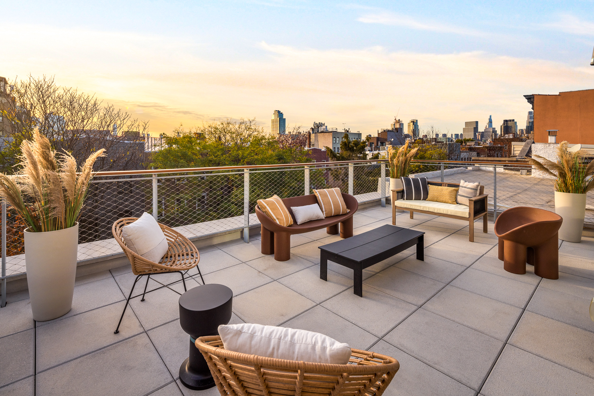 584 Leonard Street, Unit PHB Brooklyn, NY 11222 - Photo 10 of 22 a roof deck with couches and potted plants with sky view