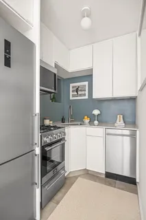 a kitchen with cabinets appliances and a sink