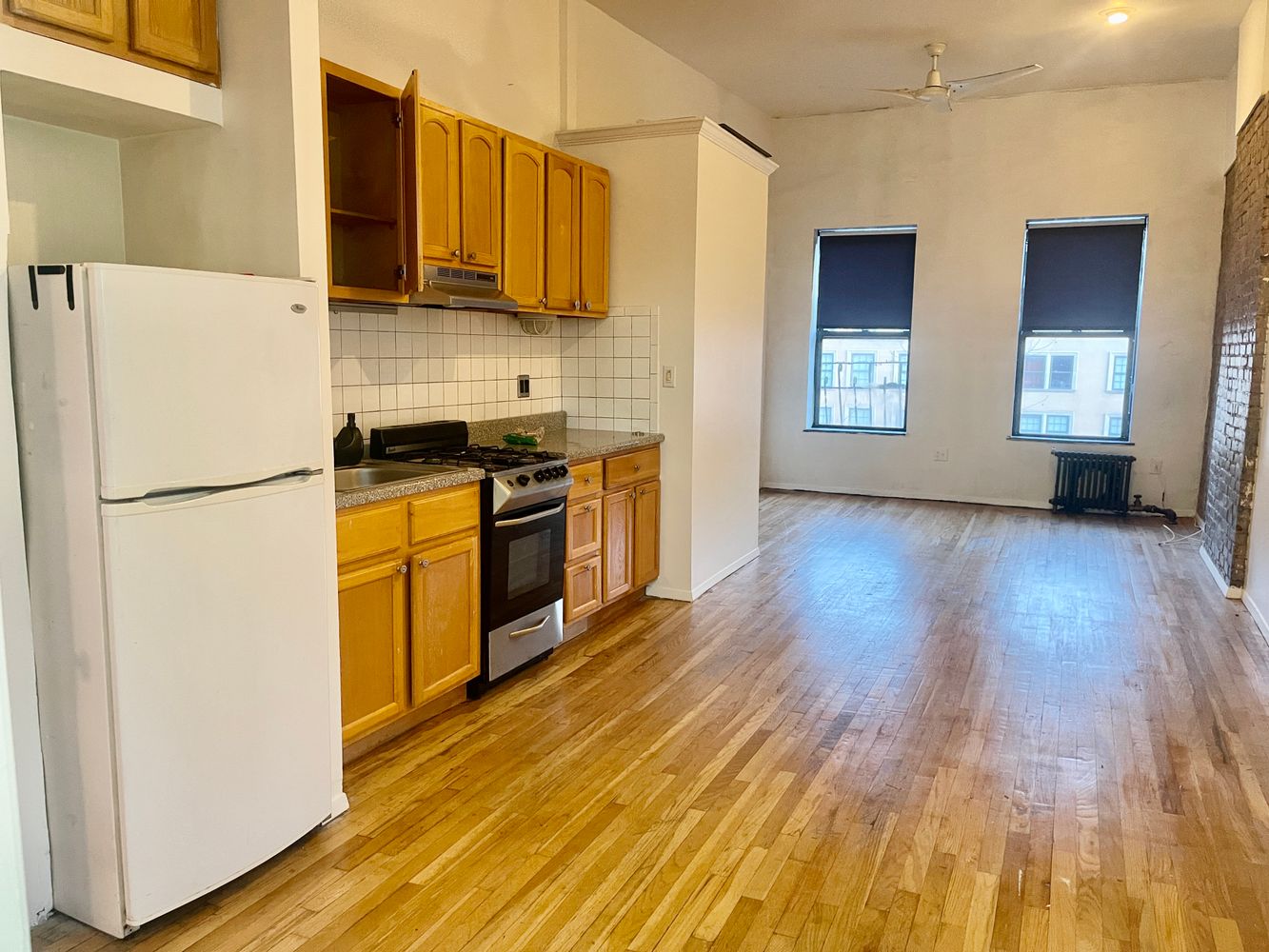 1672 Park Avenue Manhattan, NY 10035 - Photo 12 of 35 a kitchen with stainless steel appliances granite countertop a refrigerator a stove top oven a sink and dishwasher with wooden floor