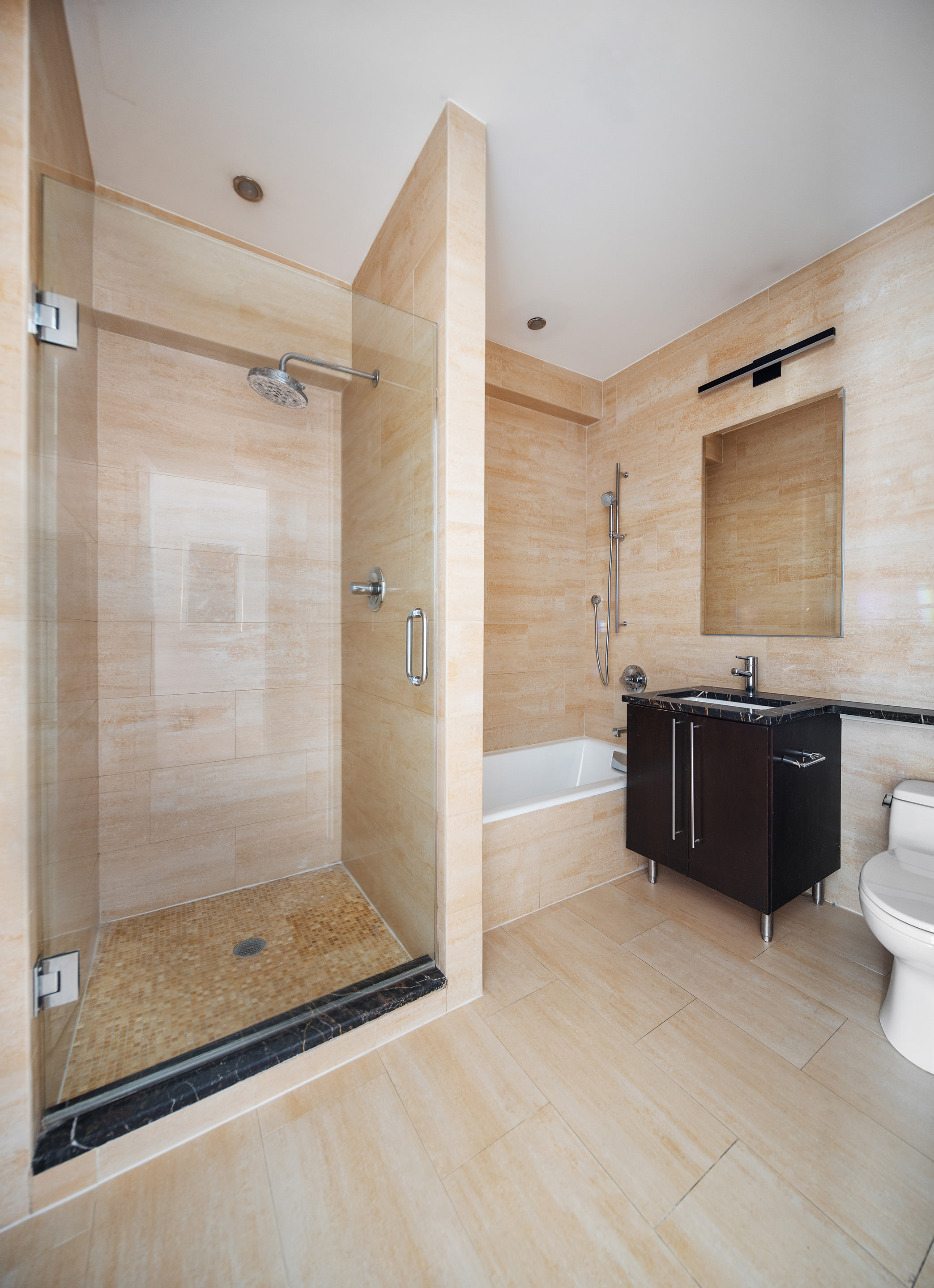 267 West 124th Street, Unit 4B Manhattan, NY 10027 - Photo 11 of 15 a bathroom with a granite countertop sink mirror and shower