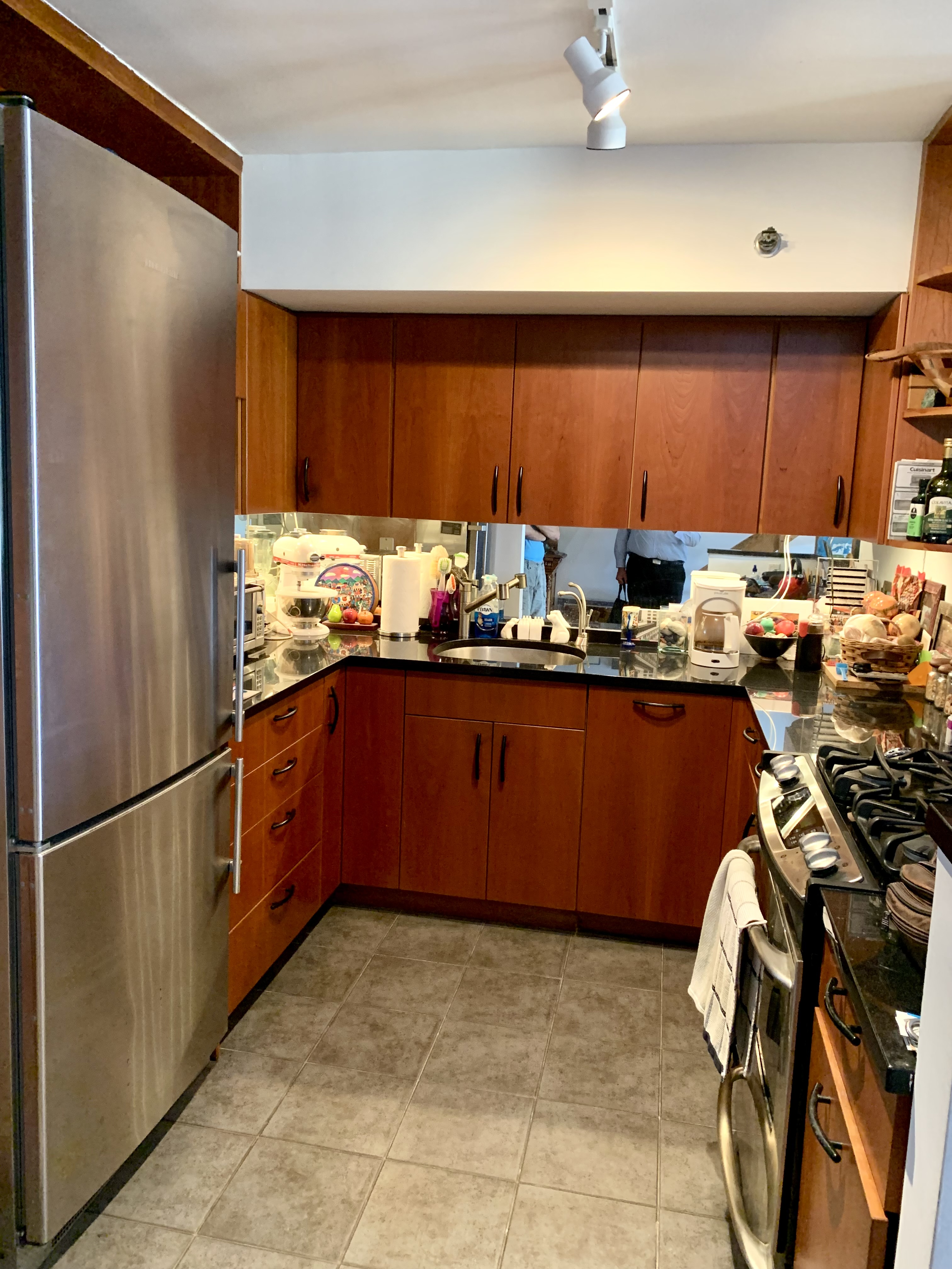 130 Barrow Street, Unit PH508 Manhattan, NY 10014 - Photo 4 of 14 a kitchen with a refrigerator and a stove top oven