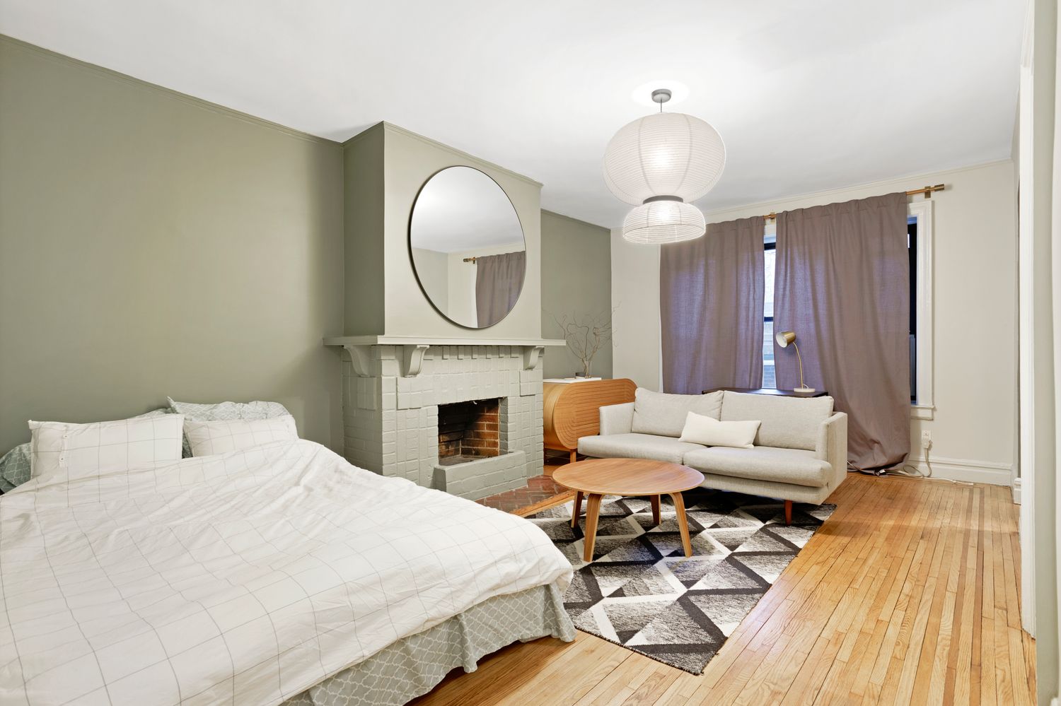 22 Grove Street, Unit 1F Manhattan, NY 10014 - Photo 2 of 9 a bedroom with a bed and a chandelier