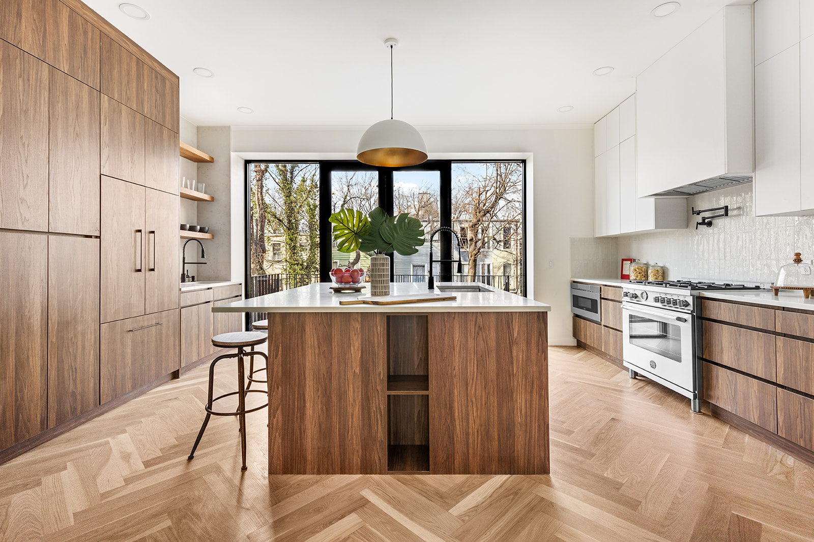 a living room with stainless steel appliances kitchen island granite countertop furniture and a large window
