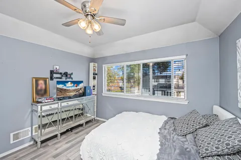 a bedroom with furniture and a flat screen tv