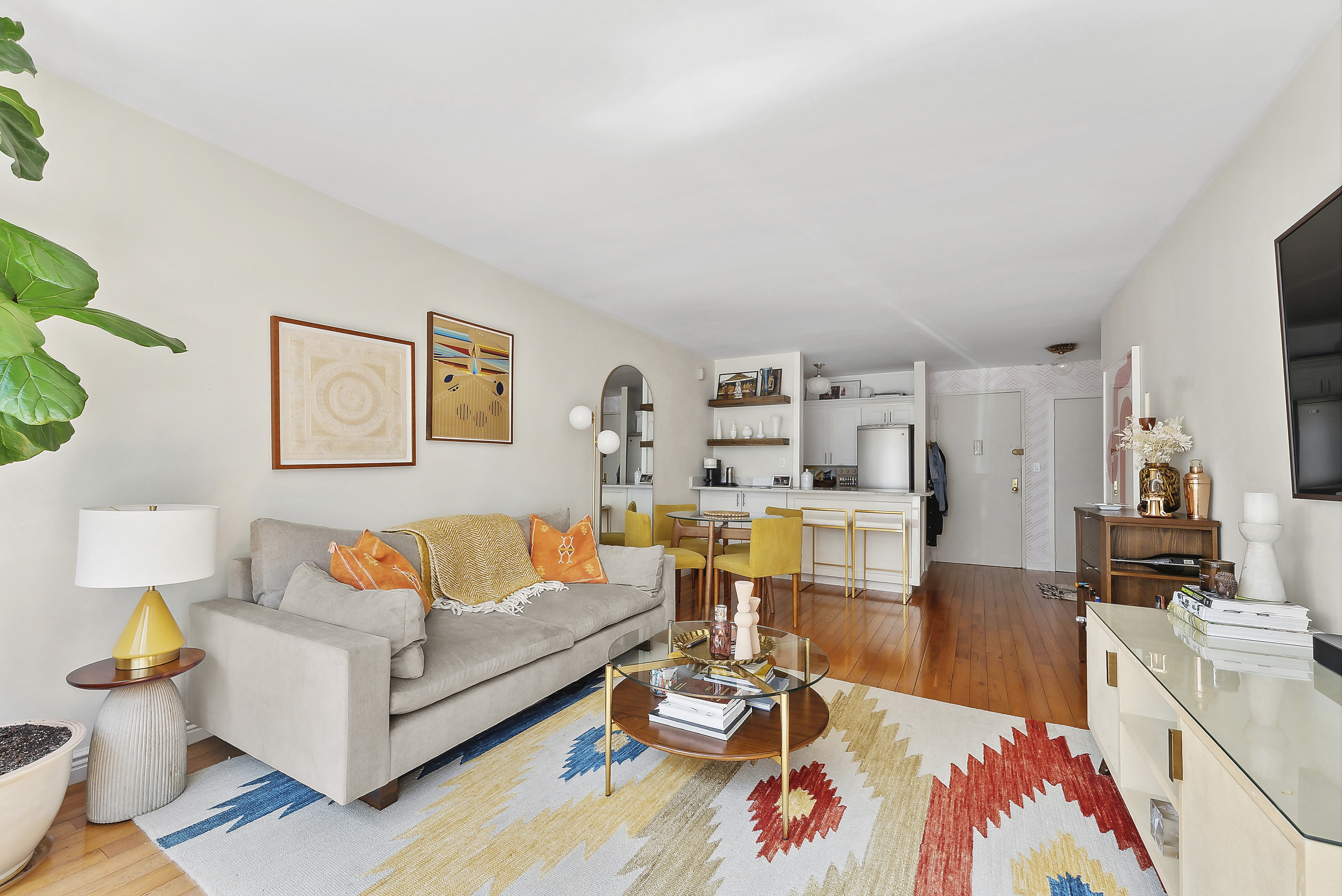 245 East 24th Street, Unit 10D Manhattan, NY 10010 - Photo 2 of 6 a living room with furniture and wooden floor