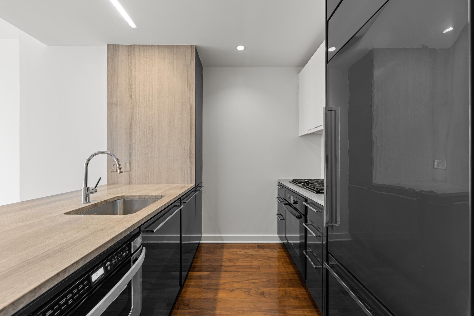 2 Northside Piers, Unit 30Y Brooklyn, NY 11249 - Photo 5 of 22 a kitchen with granite countertop a sink stove and refrigerator