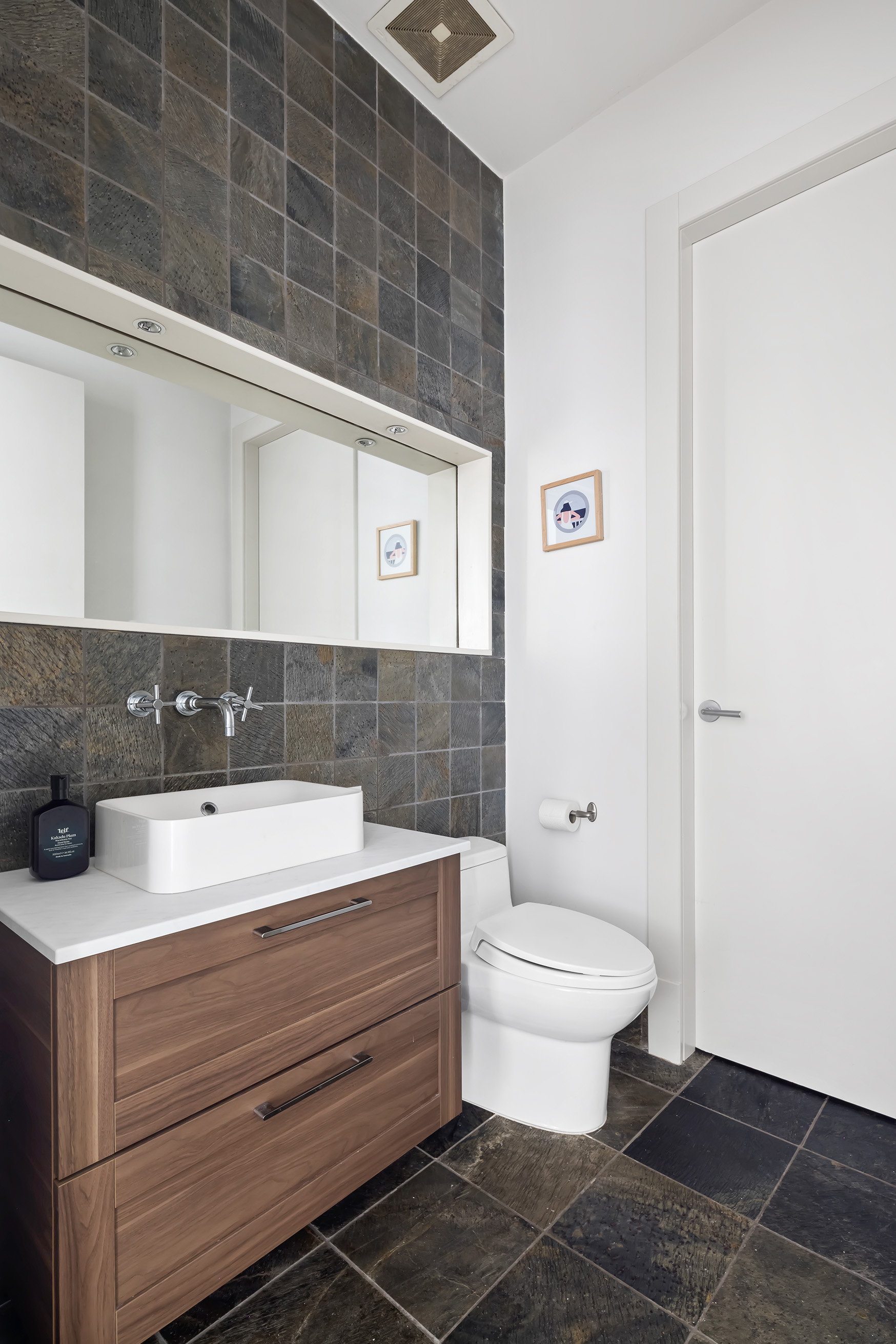 60 Broadway, Unit 6H Brooklyn, NY 11249 - Photo 10 of 16 a bathroom with a toilet a sink and mirror