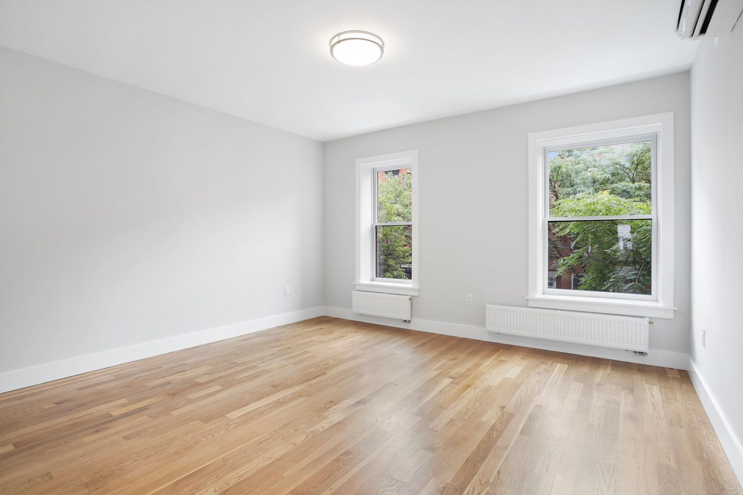 136 Union Street, Unit 2 Brooklyn, NY 11231 - Photo 6 of 9 an empty room with wooden floor and windows