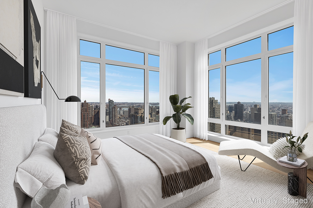 200 East 83rd Street, Unit 34A Manhattan, NY 10028 - Photo 12 of 34 a bedroom with a bed and a large window