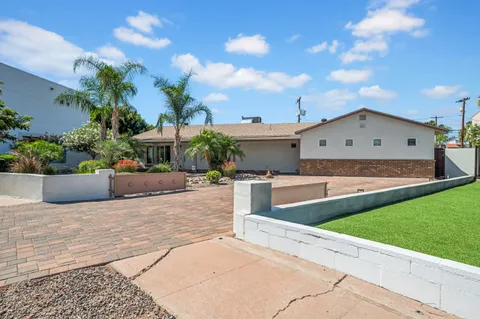 a view of a house with a yard and sitting area