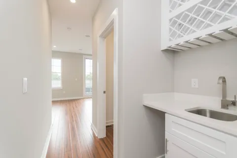 a kitchen with a sink and chandelier