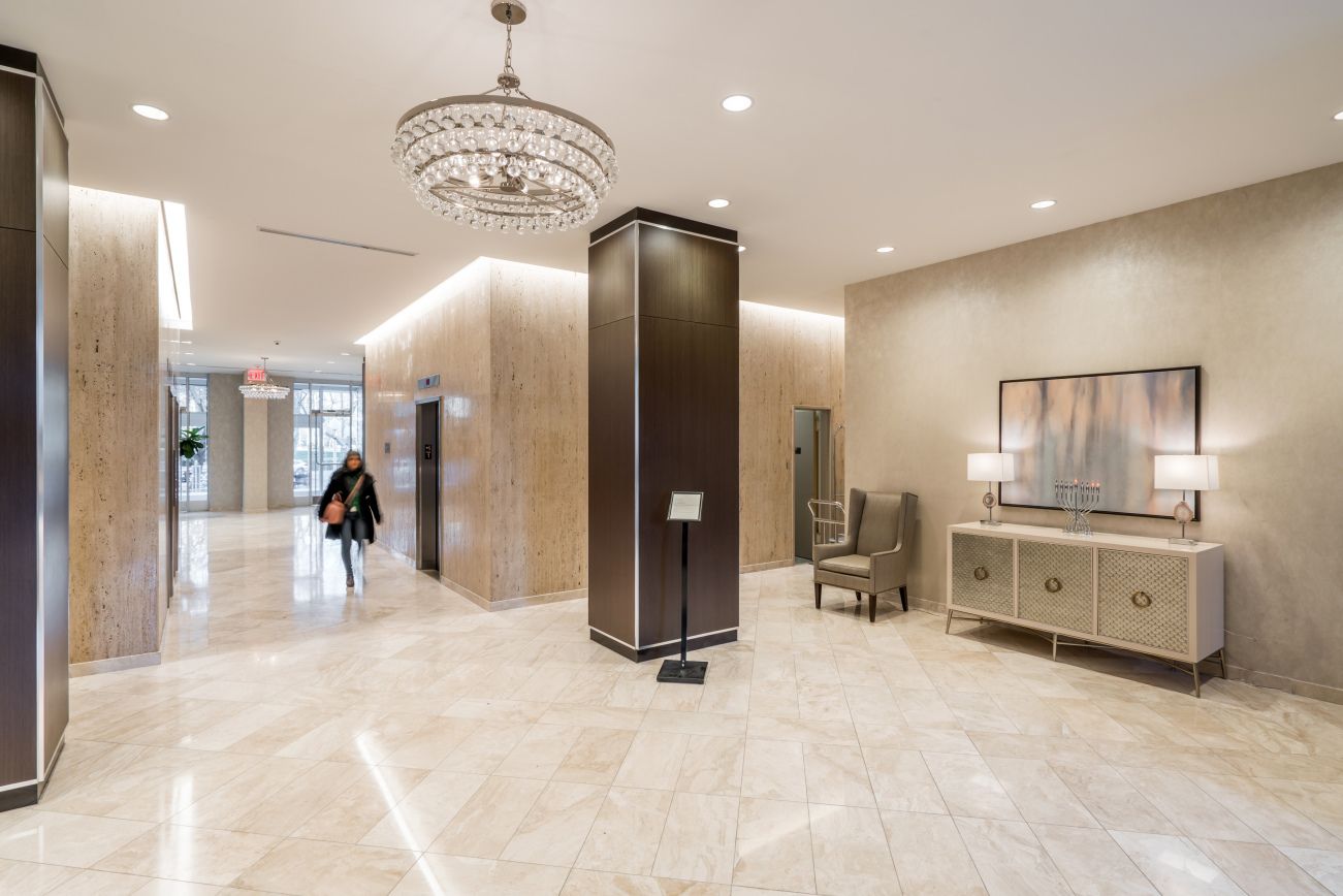 a view of a kitchen with refrigerator and window