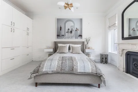 a living room with lots of books and a book shelf