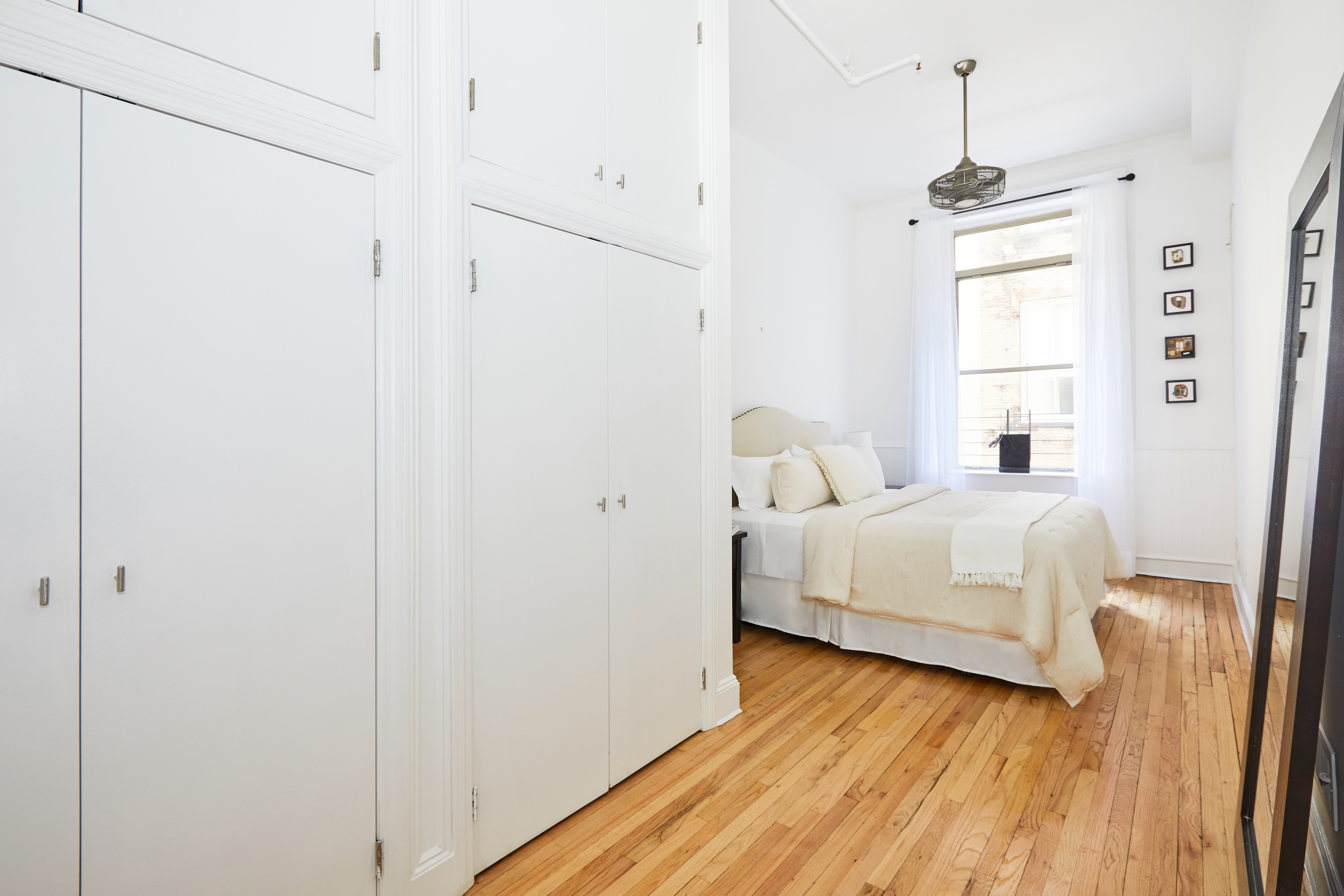 80 Leonard Street, Unit 3G Manhattan, NY 10013 - Photo 19 of 30 a bedroom with a bed and a window