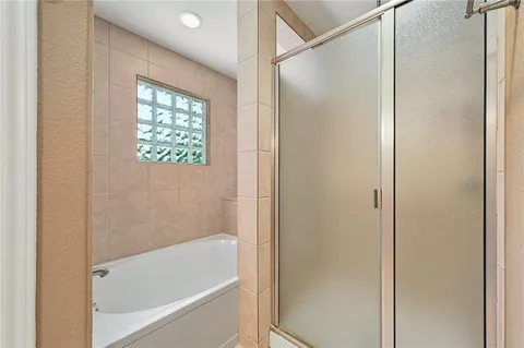 a bathroom with a bathtub and a shower