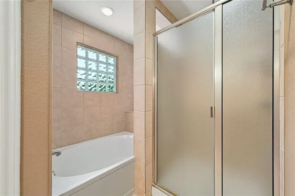 a bathroom with a bathtub and a shower